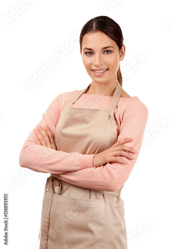 Young woman in apron standi...