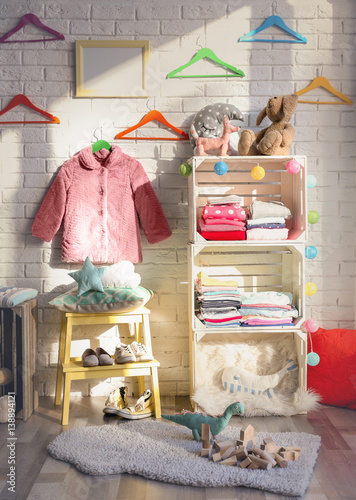 Clothes on shelf in kids room