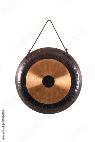 the image of the old traditional gong.percussion instrument tom-tom isolated on white hanging on a rope