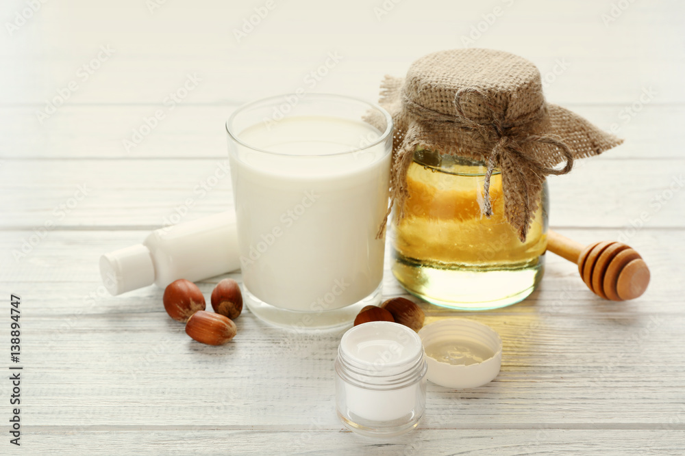 Honey, milk and cosmetics on wooden background Honey, milk and cosmetics on wooden background