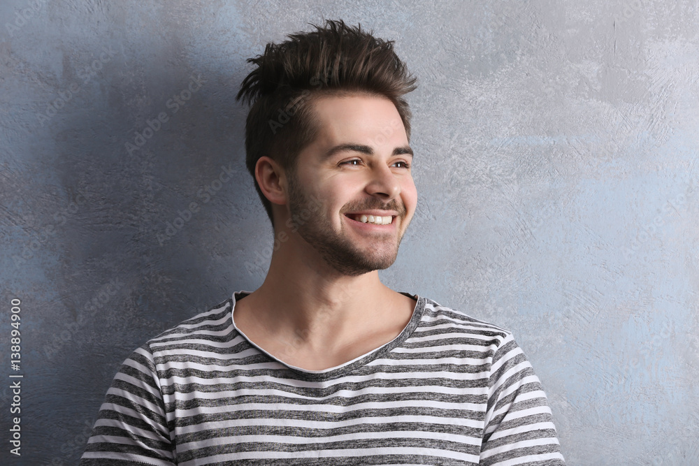 Handsome young man on color background
