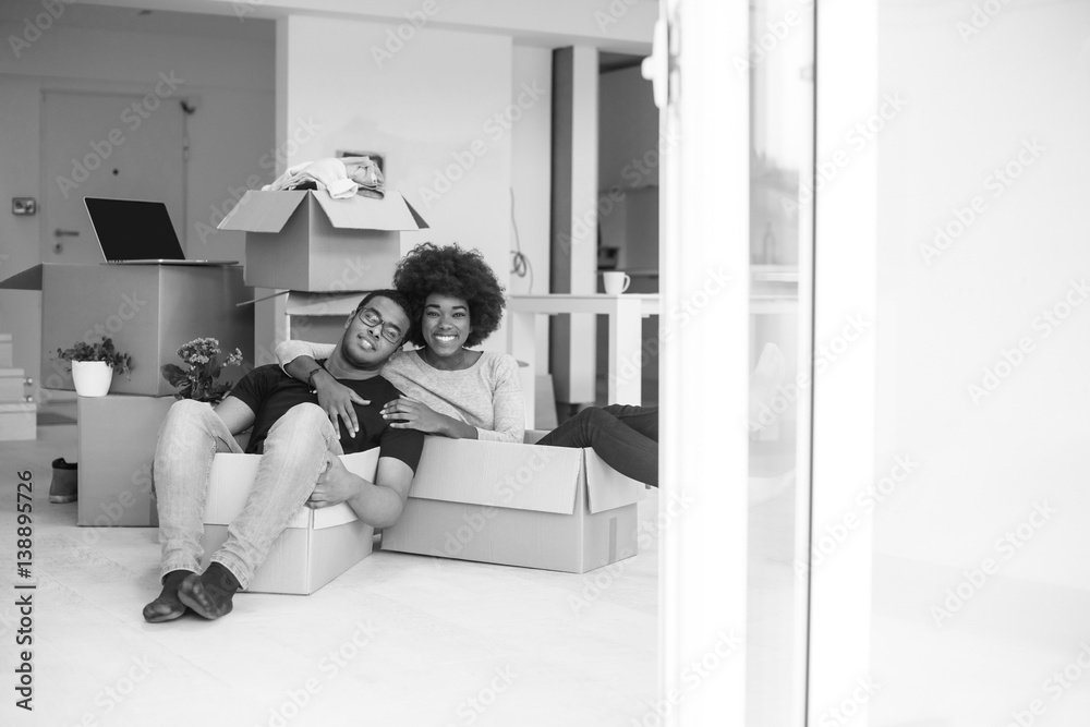 African American couple playing with packing material African American couple playing with packing material