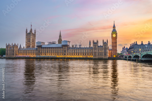 Houses of Parliament from across the River Thames at dusk. Part of Westminster Bridge can be seen
