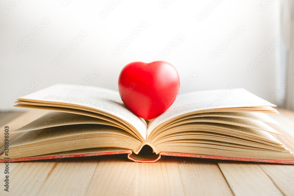 red heart on open book with copy space in relaxation and cozy mood, Image for education, love and brightness concept red heart on open book with copy space in relaxation and cozy mood, Image for education, love and brightness concept