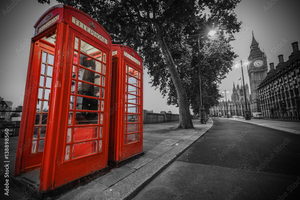 Traditional red phone booth in London with the Big Ben in the background Traditional red phone booth in London with the Big Ben in the background