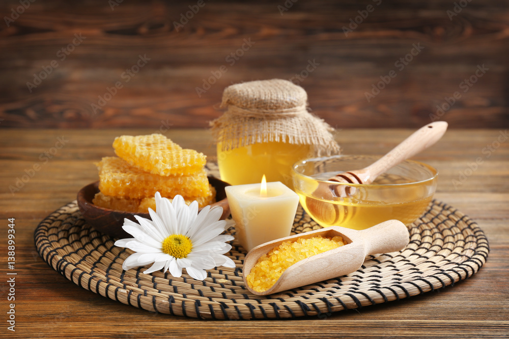 Honey spa set on wicker mat and wooden background