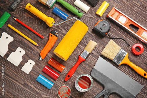 Fotografie Flat lay composition of decorator and house renovation tools on wooden table