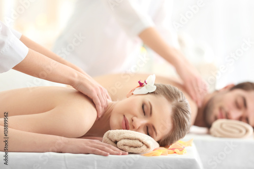 Young happy couple relaxing in spa salon