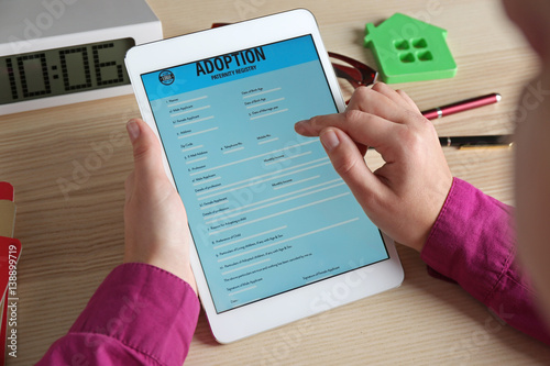 Photography Woman filling adoption paternity registry in tablet