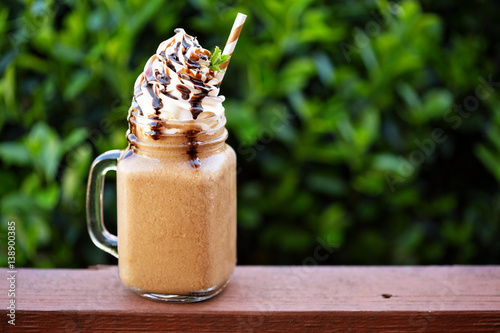 Obraz na plátně Chocolate frappe coffee with whipped cream outside