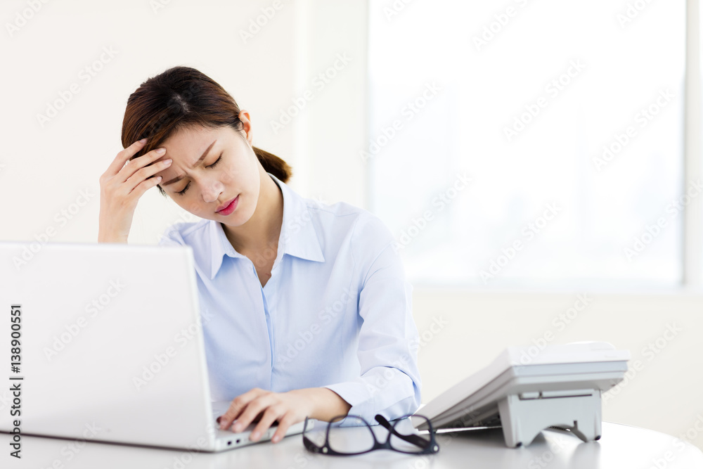 Young businesswoman with tired eyes and headache Young businesswoman with tired eyes and headache