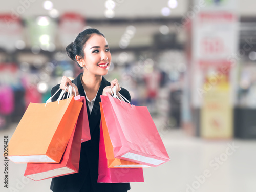 soft focus women holding shopping bags in her hand with blurred background