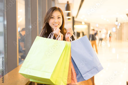 young asian woman shopping in modern shopping mall