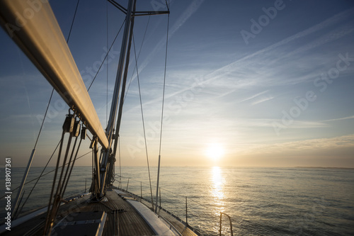 Fototapeta Naklejka Na Ścianę i Meble -  Sail Boat Sailing In Sea During Sunset