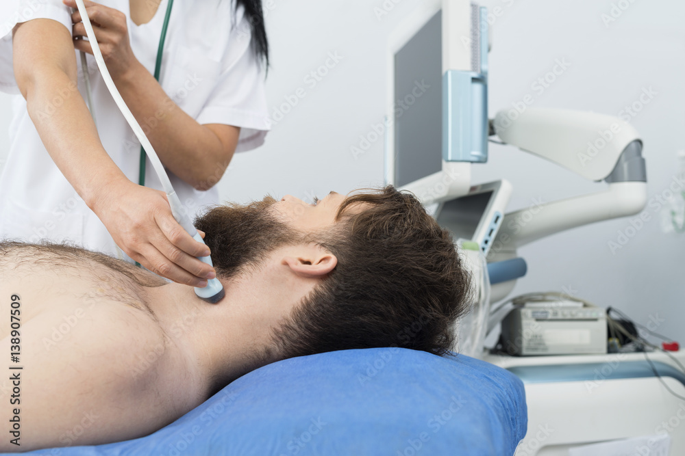Patient Undergoing Ultrasound Of Thyroid From Doctor Patient Undergoing Ultrasound Of Thyroid From Doctor