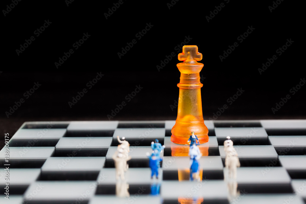 business miniature team with chess background business miniature team with chess background