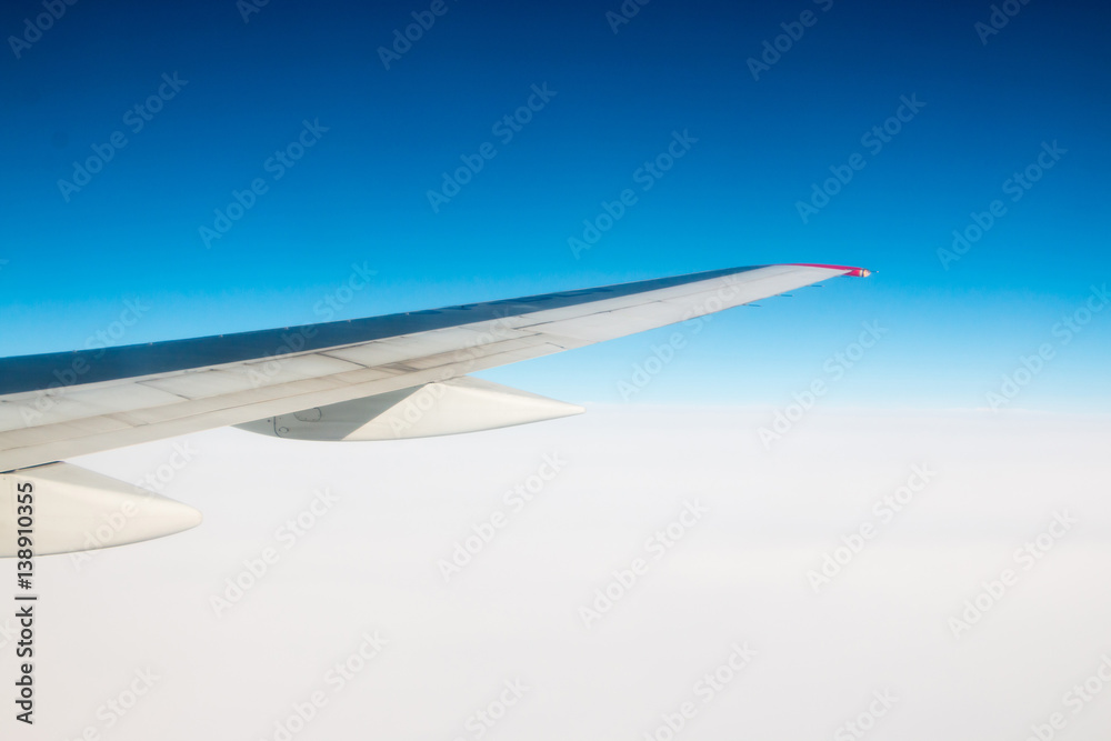 Fototapeta premium The wing of an airplane flying in the sky