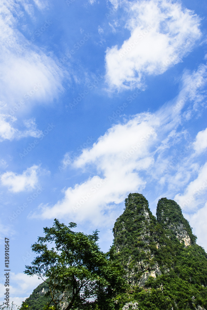 Obraz premium Karst mountains and rural scenery in summer
