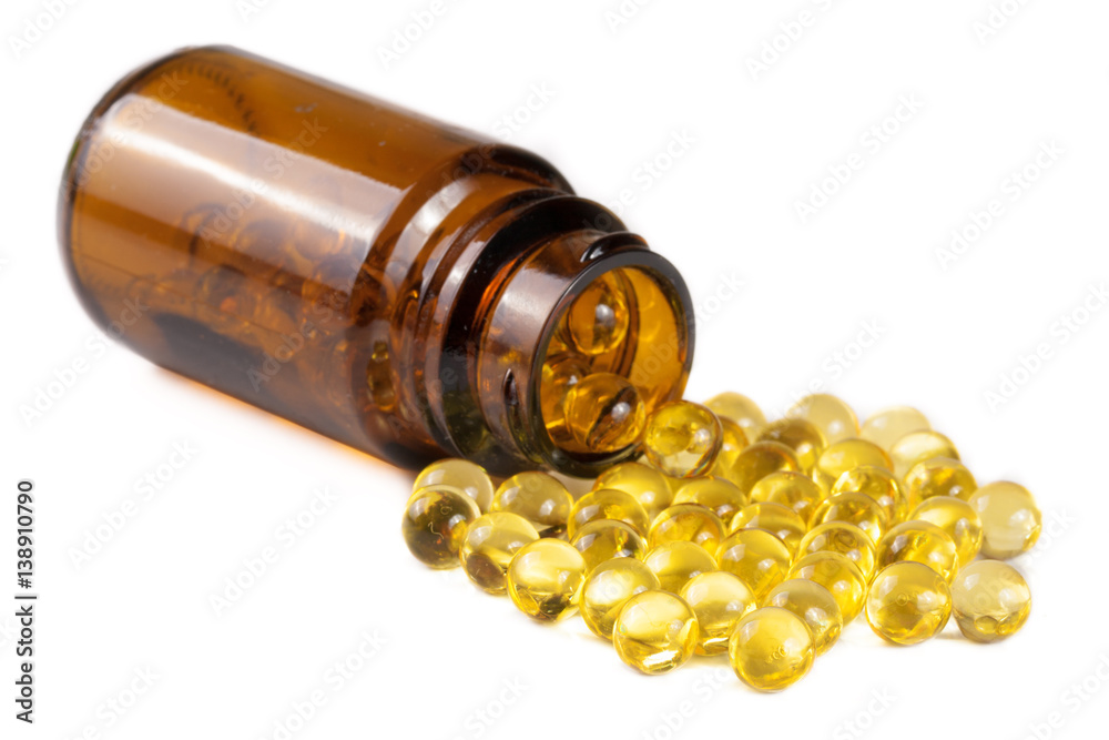Fish oil capsules in a glass bottle isolated on white background - obrazy, fototapety, plakaty 