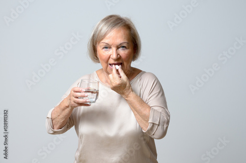 Senior woman taking pills