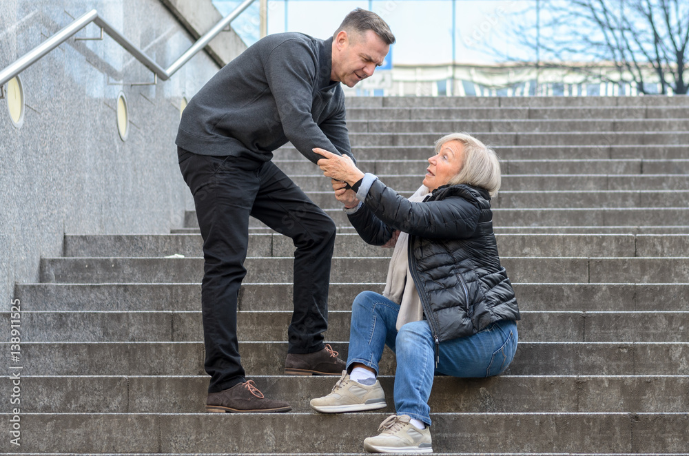 Man helping woman to get up Man helping woman to get up