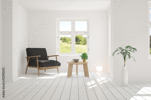 Fototapeta Naklejka Na Ścianę i Meble -  White room with armchair and green landscape in window. Scandinavian interior design