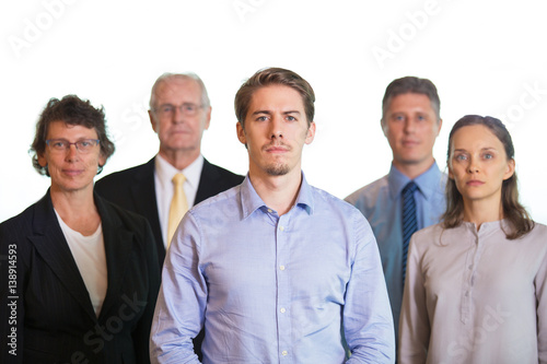 Serious Middle-aged Employee With Colleagues