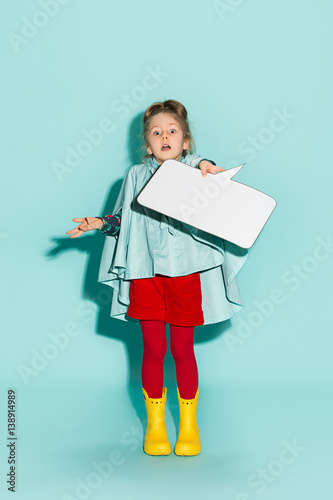 Little girl posing in fashion style wearing autumn clothing.