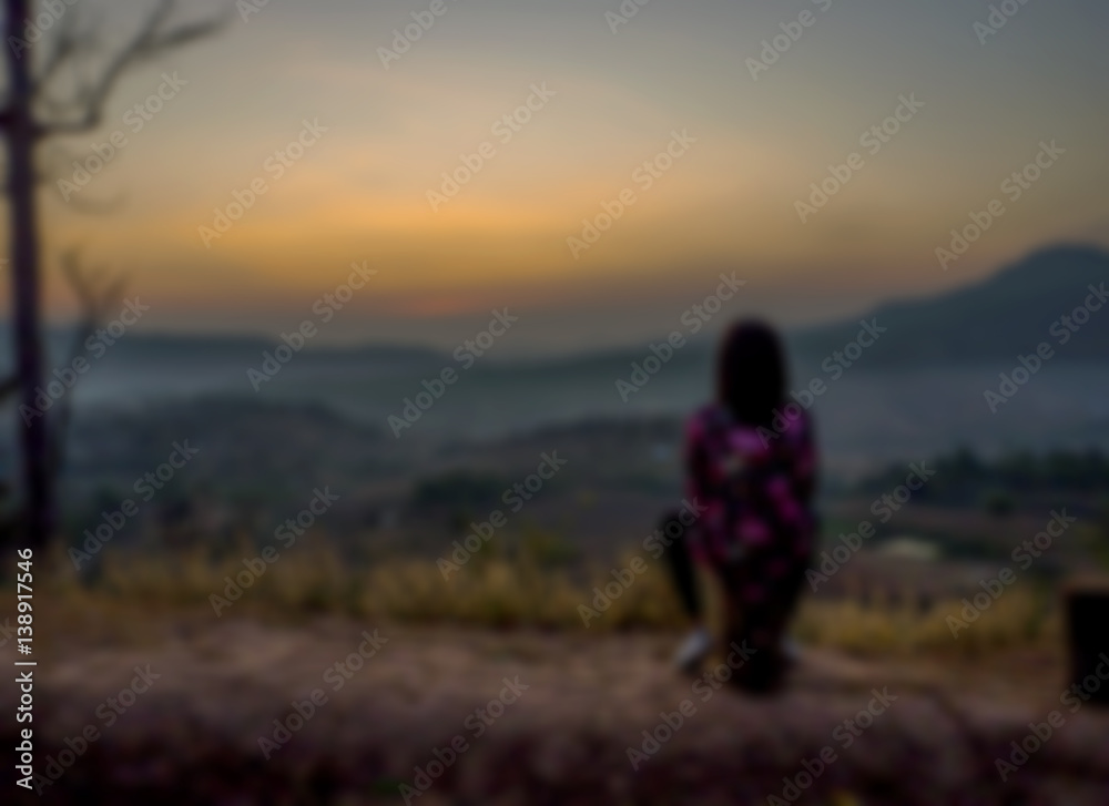 Woman sit see to the sunrise