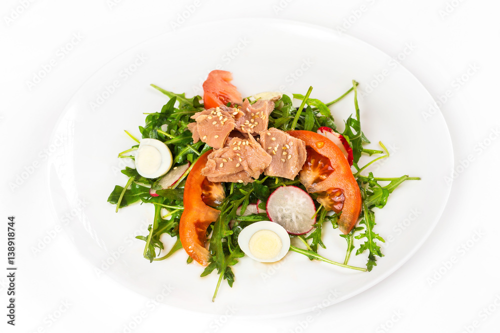 Plate of tuna salad with fresh vegetables isolated at white background.