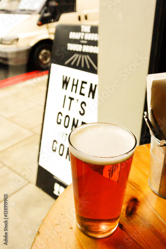 Glass of beer in front of the sign 