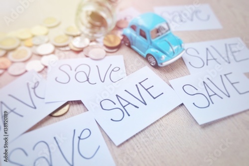 Soft focus The cost of maintaining a car. Saving money to buy a dream car. The concept of saving money. Toy cars and composing artificial light.