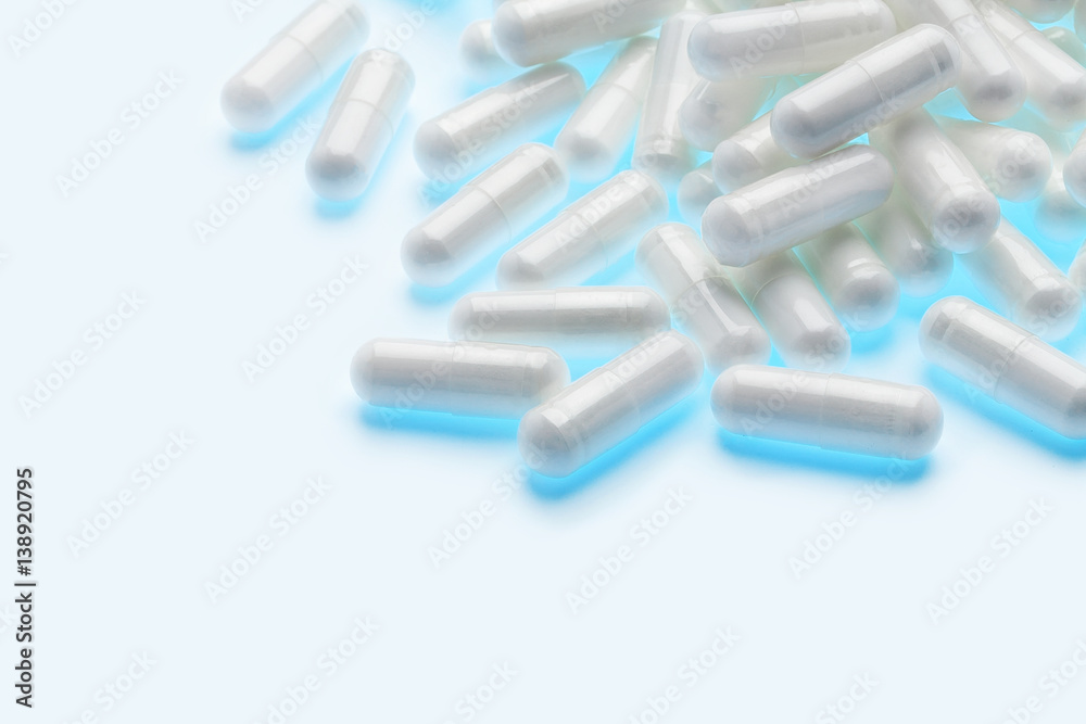Pile of glowing capsules on white background. Copy space. High resolution product. Health care concept Pile of glowing capsules on white background. Copy space. High resolution product. Health care concept