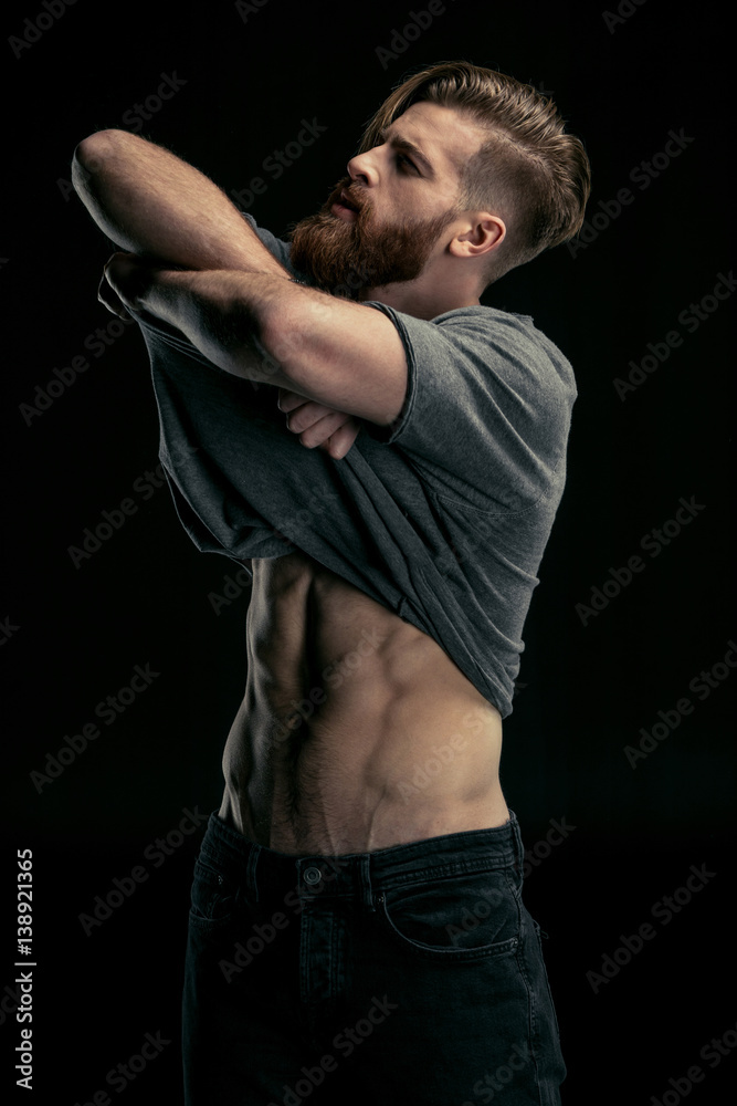 stylish man taking away shirt on black stylish man taking away shirt on black