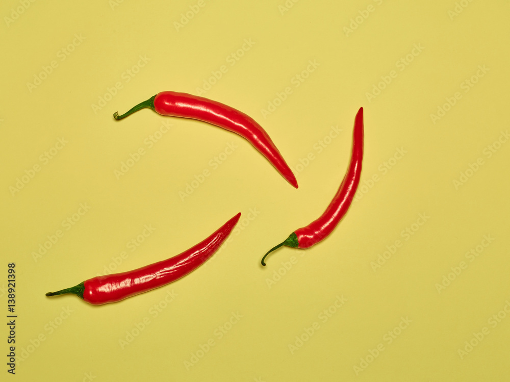 bitter chili pepper and paprika on a yellow background bitter chili pepper and paprika on a yellow background