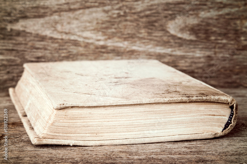 Book lies on wooden background