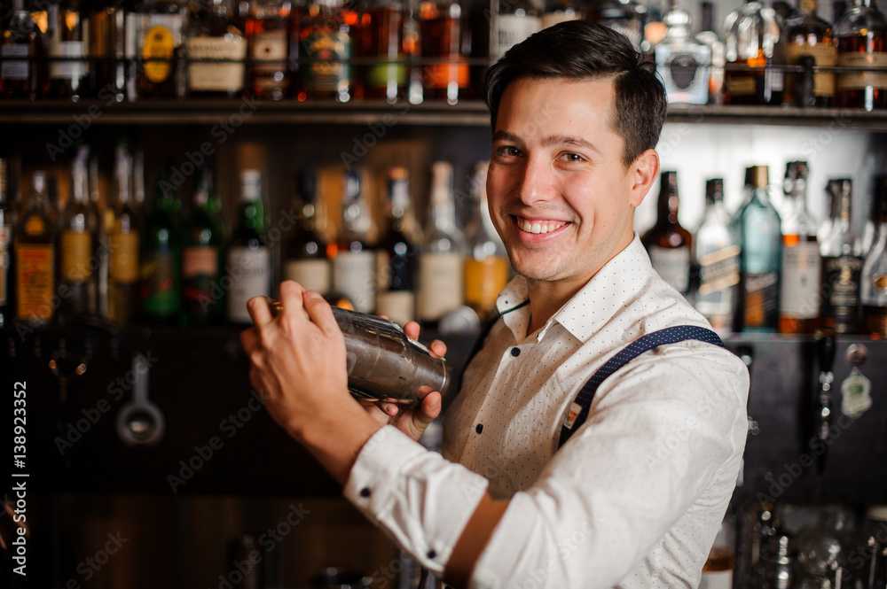 smiling bartender shaking coctail