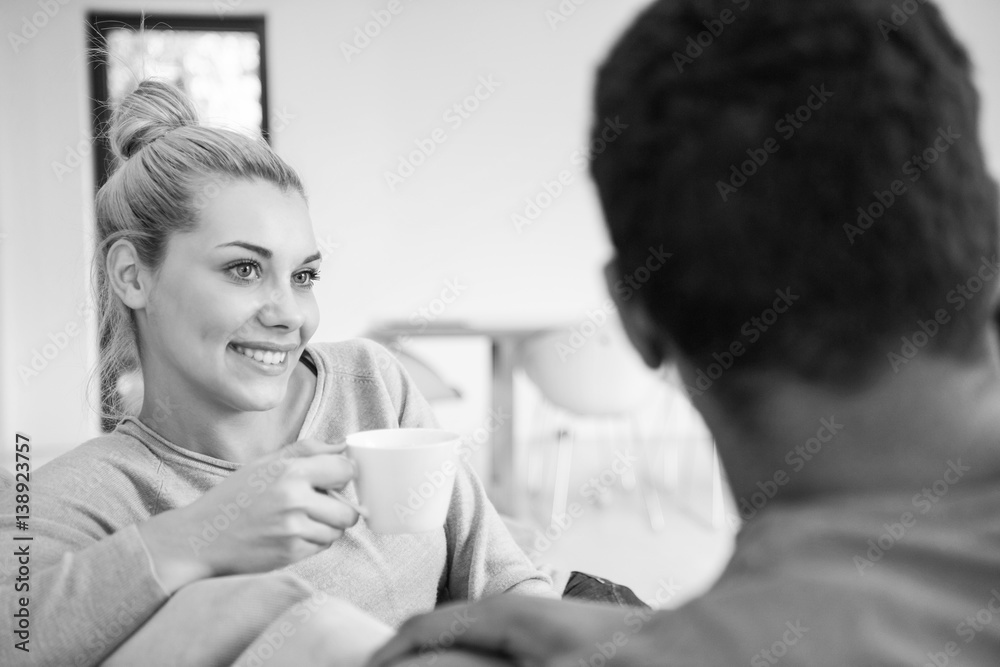 Young multiethnic couple in front of fireplace Young multiethnic couple in front of fireplace