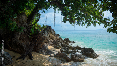 Rocky Tropical Beach Cove, with Shady Tree and Turquoise Sea - Camiguin Island, Philippines photo