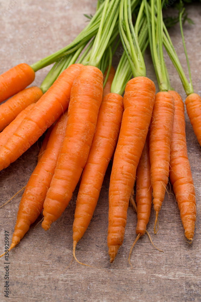 Fresh and sweet carrot on a grey wooden table. Fresh and sweet carrot on a grey wooden table.