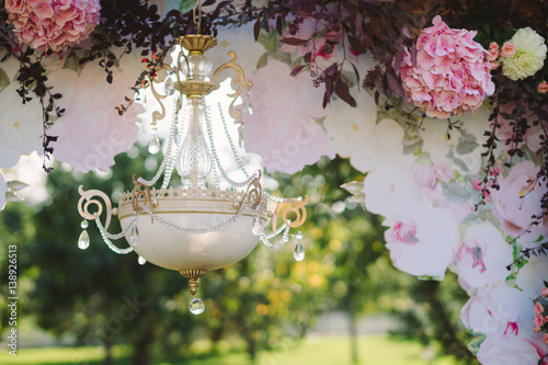 Closeup of vintage chandelier as a part of wedding ceremony decoration photo