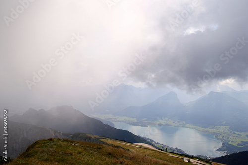 Travel to Sankt-Wolfgang, Austria. The view on the mountains and a lake in the clouds.