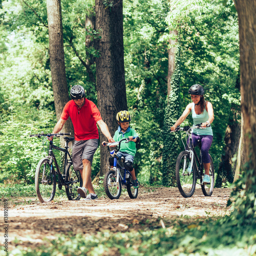 Family biking in forest