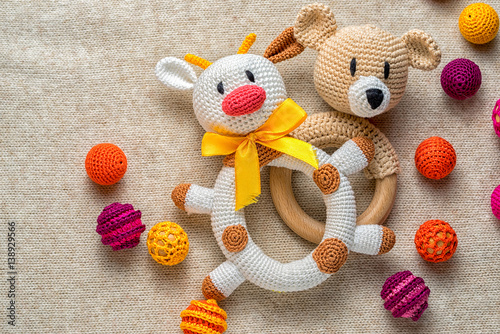 educational concept of sand pit bulls and bears in the financial market. crocheted rattle cow and bear children's toys among colorful beads. copy cpace for your text.
