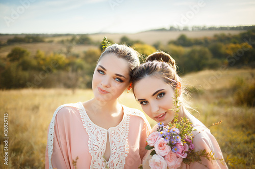 bridesmaids in pink dresses with bouquets photo