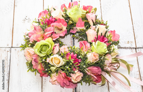 Wedding wreath with roses on white wooden background