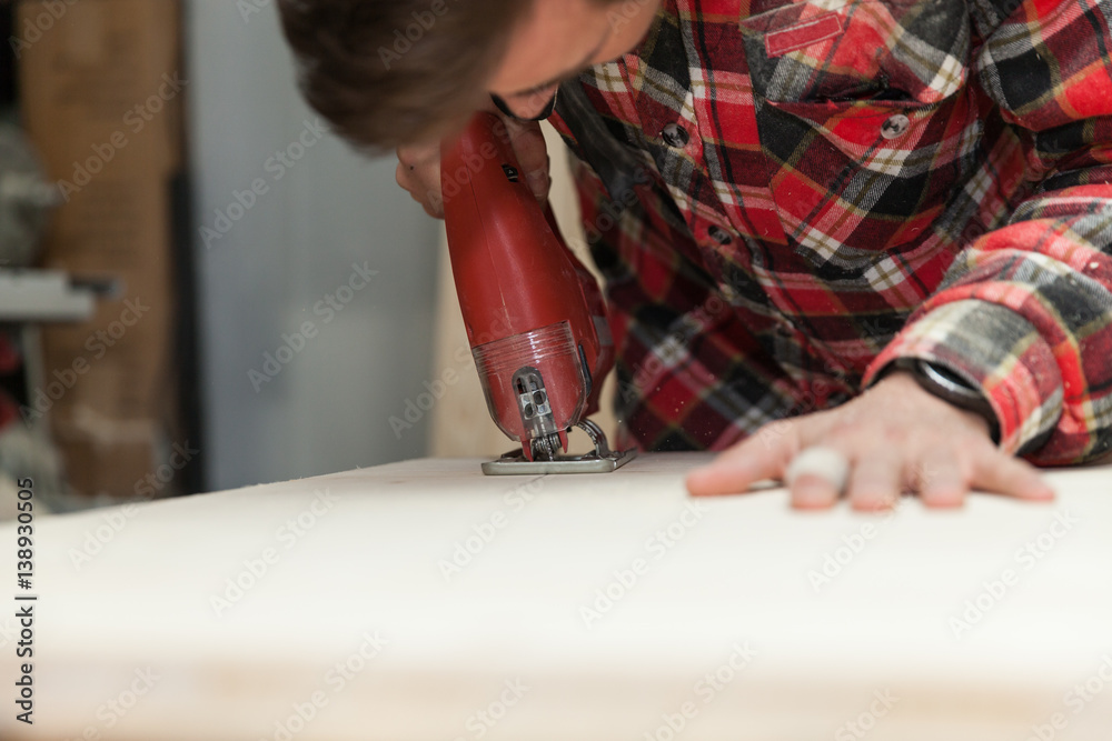 Young carpenter in his workshop Young carpenter in his workshop