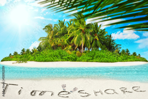 Whole tropical island within atoll in tropical Ocean and inscription  TimeShare  in the sand on a tropical island   Maldives.