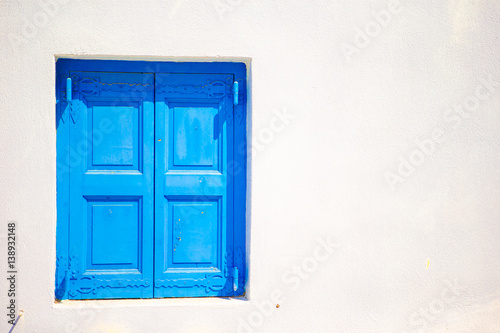 Fototapeta Naklejka Na Ścianę i Meble -  Traditional colorful window in the narrow streets of Mykonos, Greece.