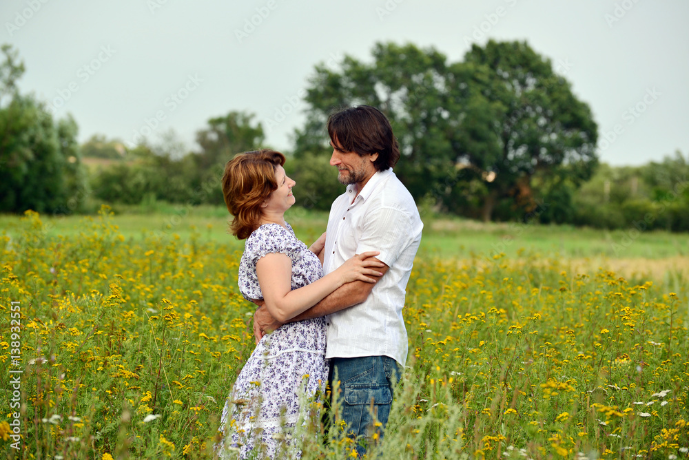 Happy middle-aged couple on nature in summer Happy middle-aged couple on nature in summer